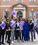 Alumni waving purple pom-poms in Vanderbilt Hall courtyard