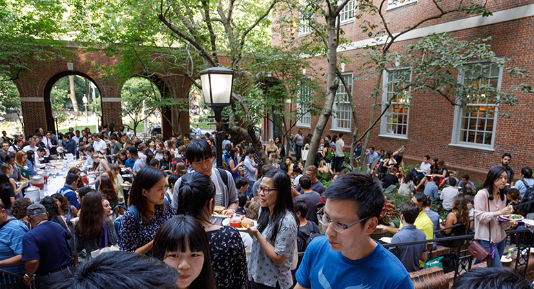 Students talking and eating in Vanderbilt Hall Courtyard for Orientation 2019 BBQ