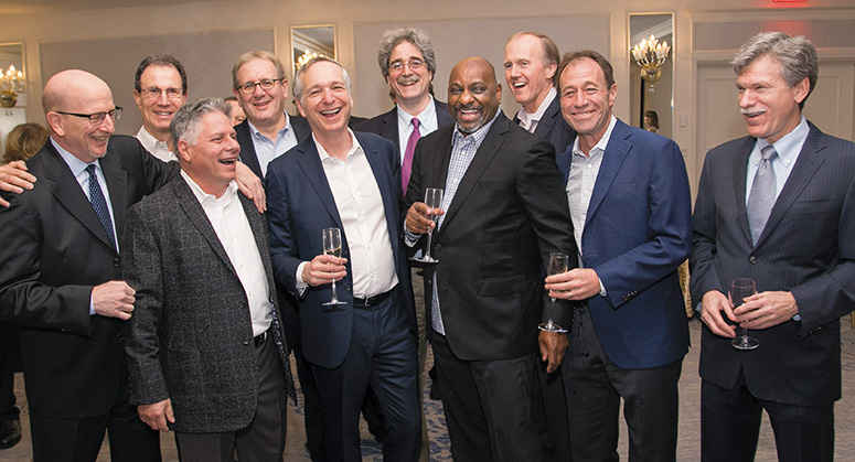 A group of alumni laughing and mingling together at the 2018 NYU Law Reunion 