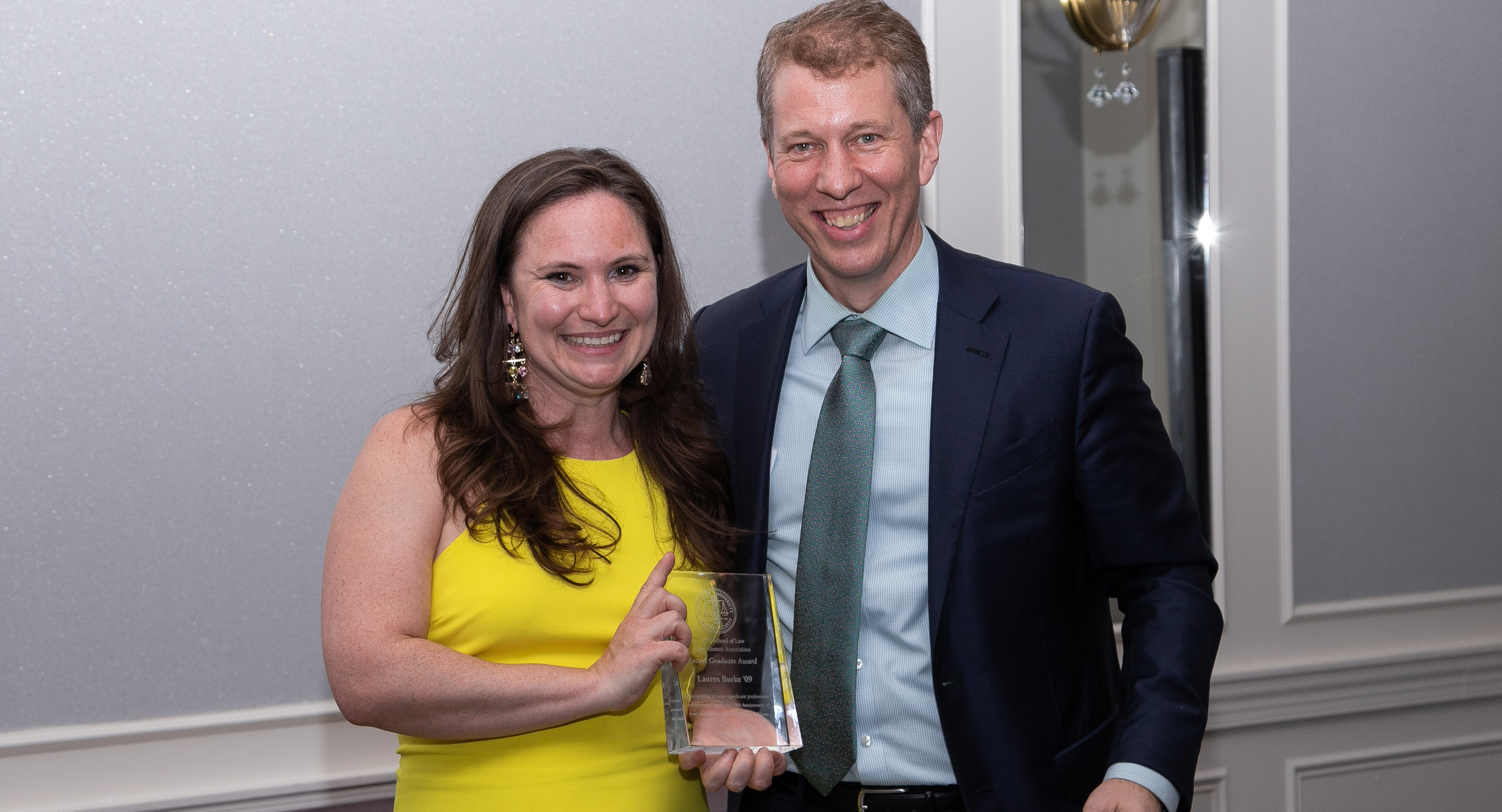 Lauren Burke receiving an award from Dean Trevor Morrison at Reunion 2019