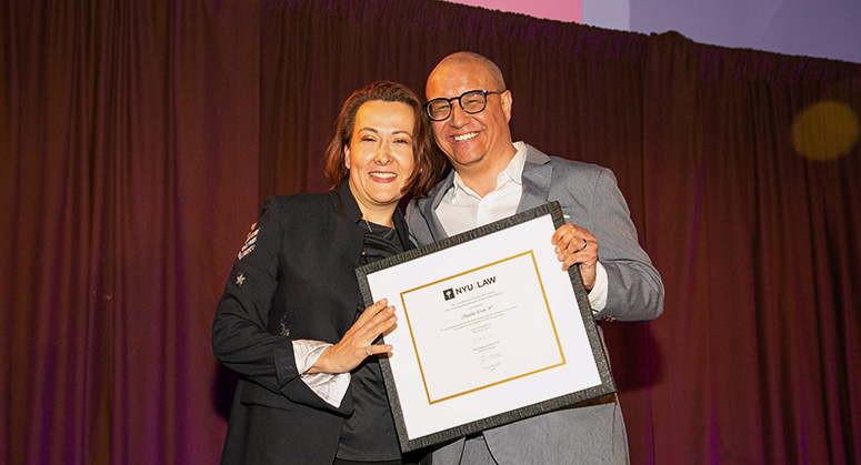 Claudia Teran ’97 being presented with award