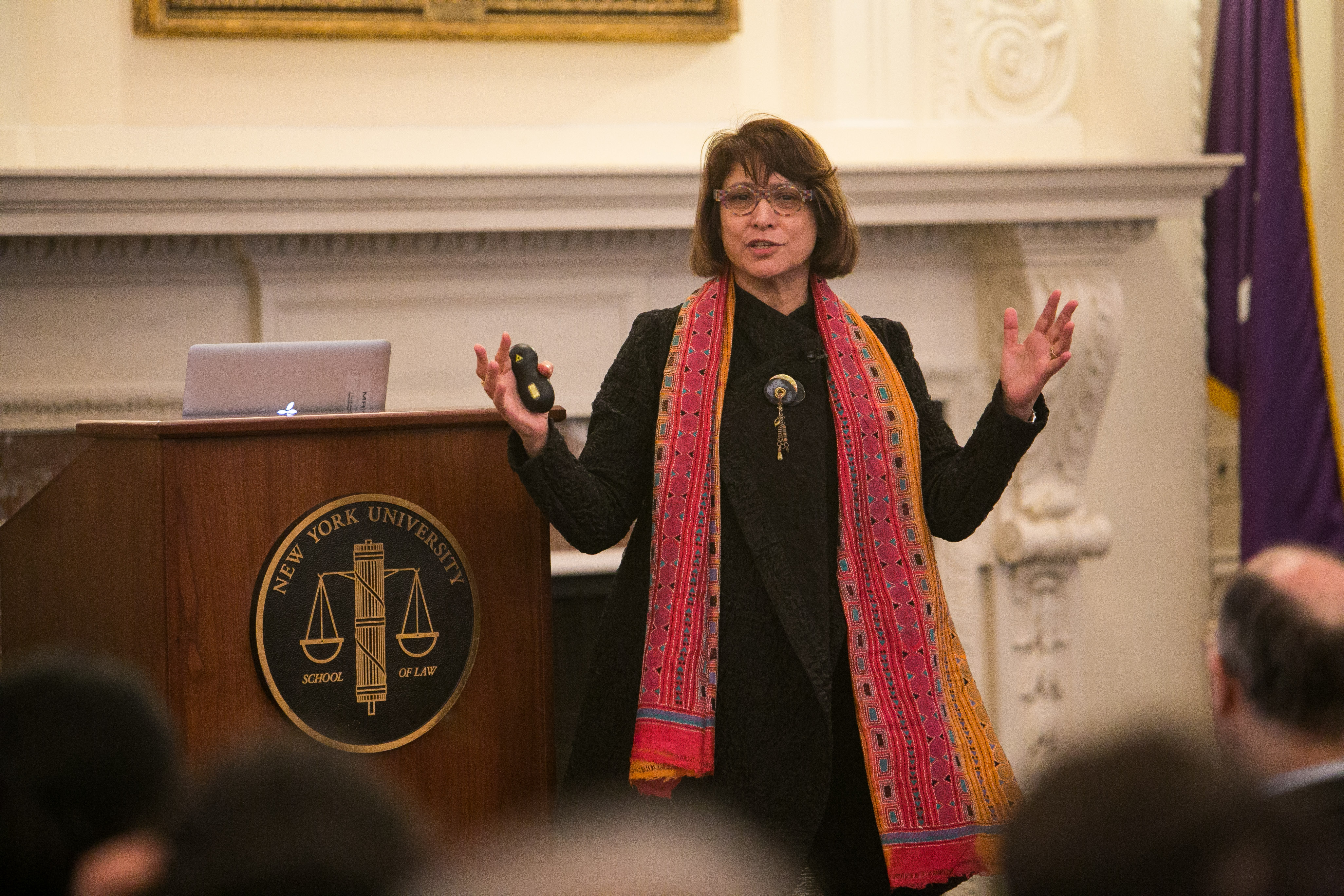 Professor Mahzarin Banaji delivering talk next to NYU Law podium