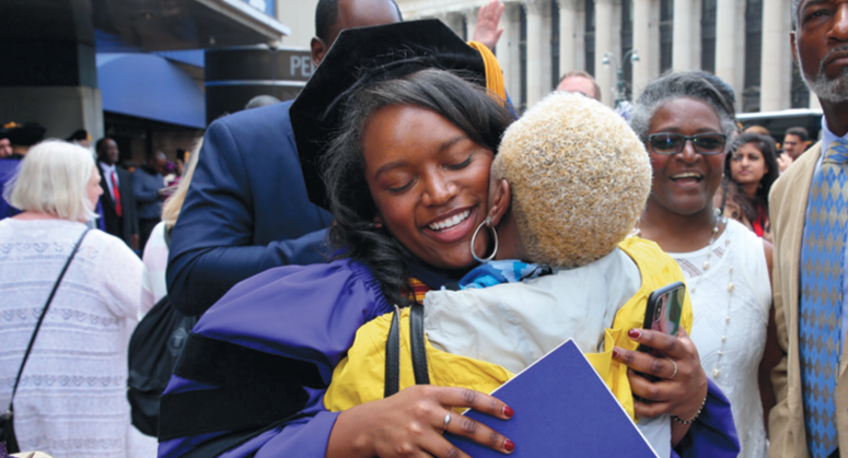 Student hugging another person at Convocation