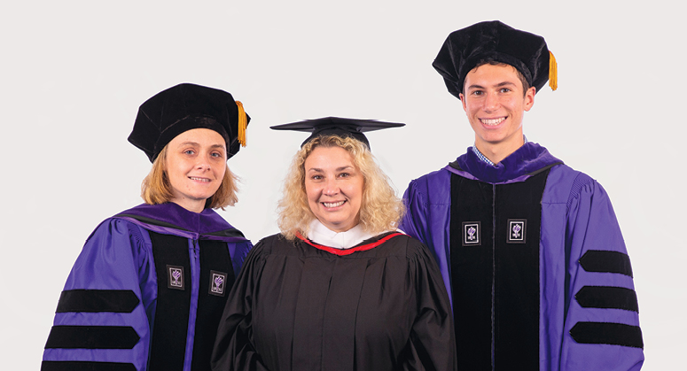 Mark A. Brisman Memorial Scholar Lucy Gray-Stack was hooded by Juliette and William Brisman