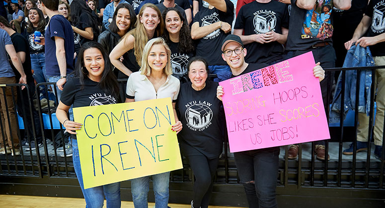 Students holding signs cheering on the faculty at the 2019 Dean's Cup