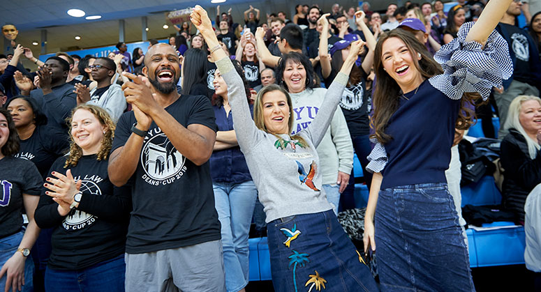 Faculty and friends cheering on the students playing in the 2019 Dean's Cup