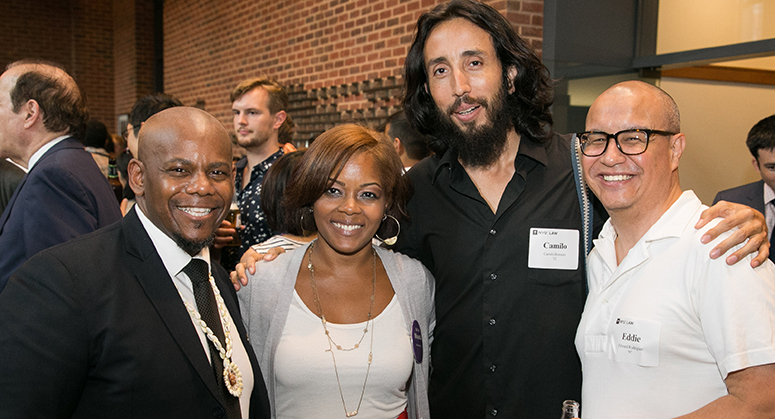 Rafiq Kalam Id-Din II ’00, LACA President, smiling with alumni at OutLaw/LACA reception