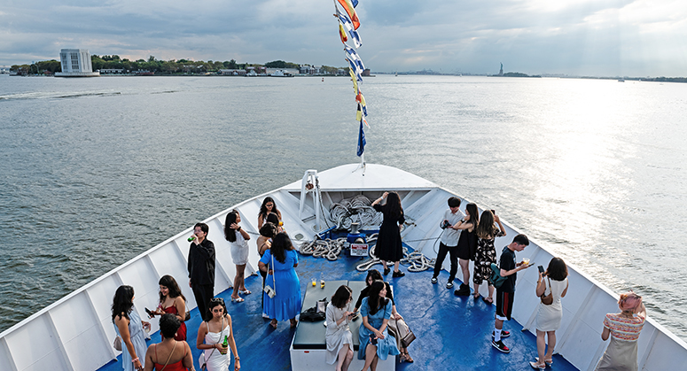 Aerial photograph of boat's bow with students gathered throughout enjoying scenic view of Hudson River