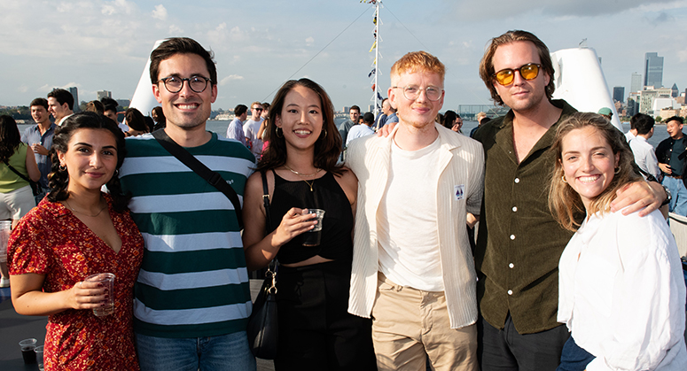 Six LLM students posed for photo on boat