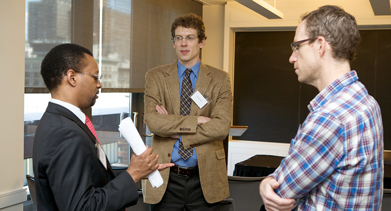 Professor and Professorial Candidates Discussing Issue at ACP Event