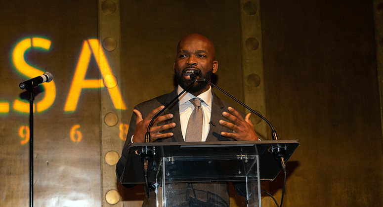 Abdul Dosunmu at a lectern