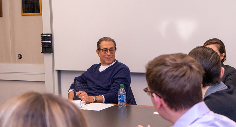 Barry Friedman with students around a seminar table 