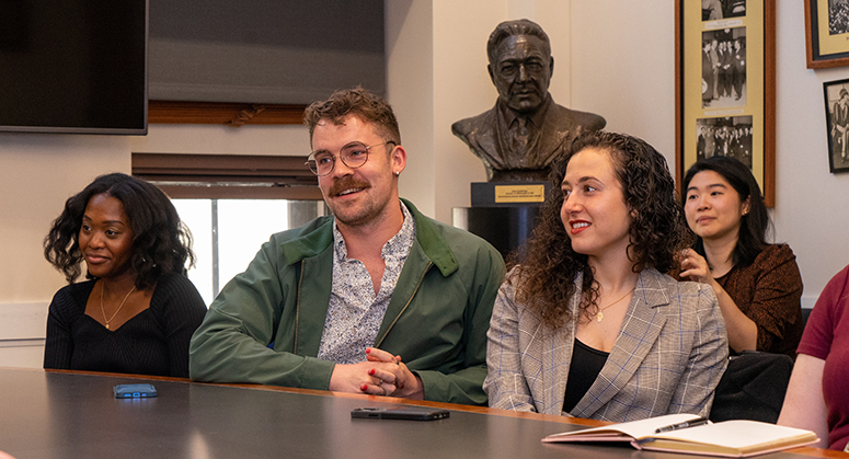 Furman scholars smiling and sitting at seminar table