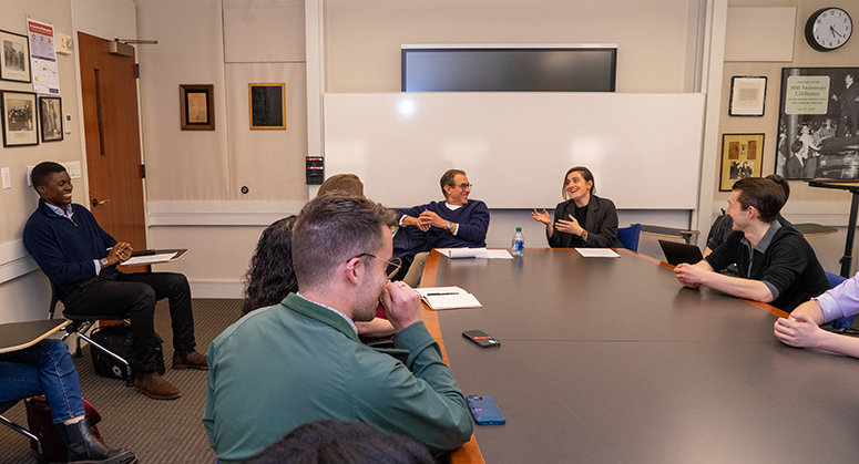 Professor Barry Friedman around a seminar table with Furman scholars, all laughing