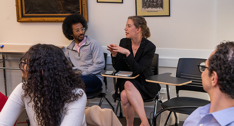 Furman scholars sitting and speaking to one another in classroom