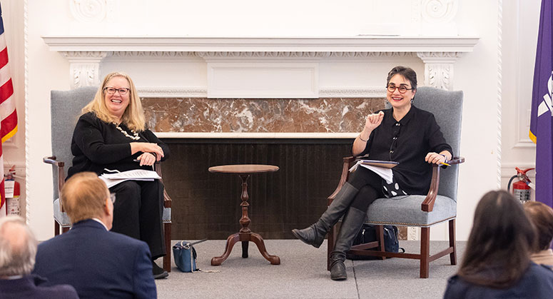 Deborah Burand and Maria Santos Valentin smiling at the audience