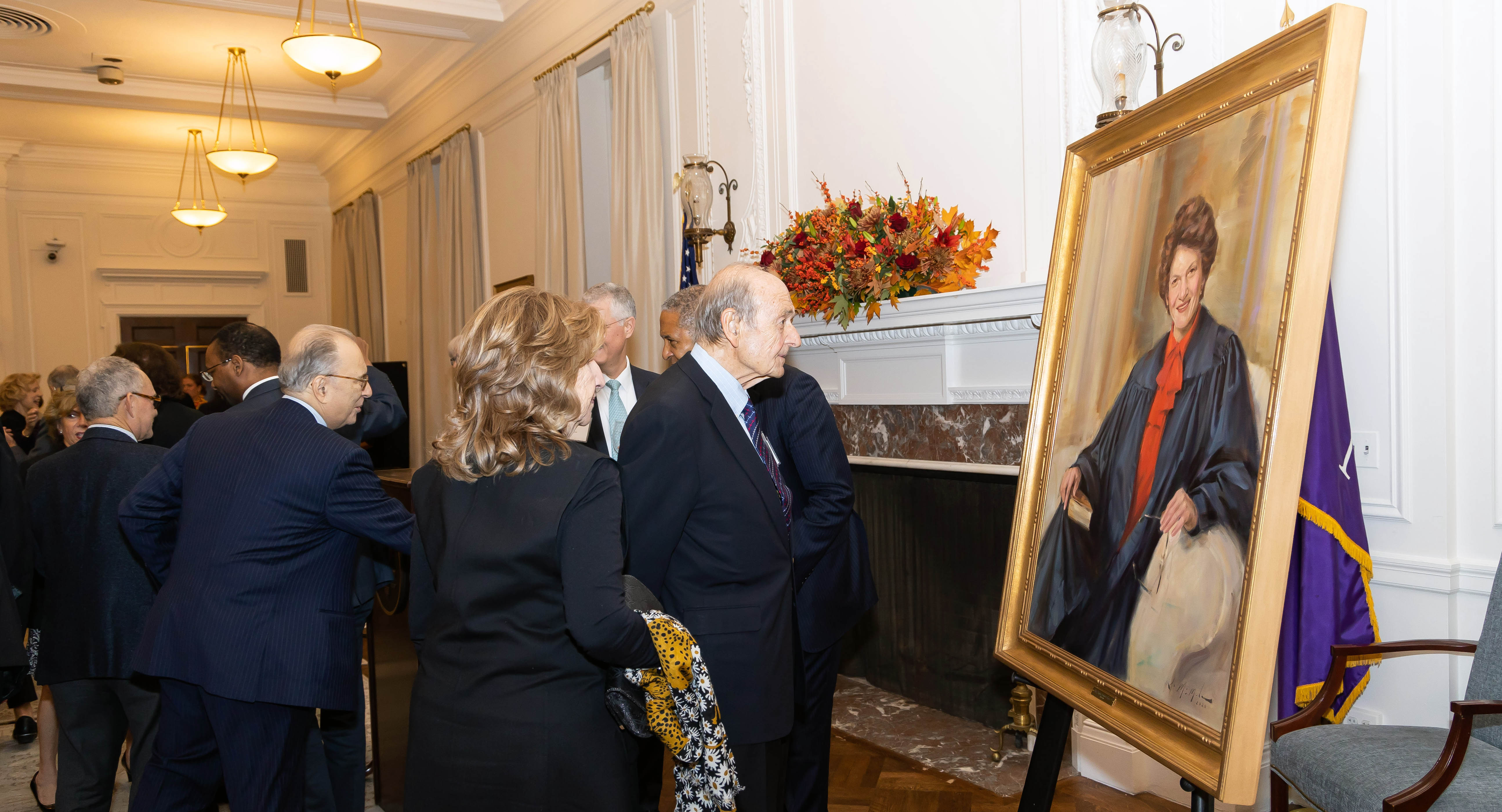 Attendees admire Judith Kaye's portrait