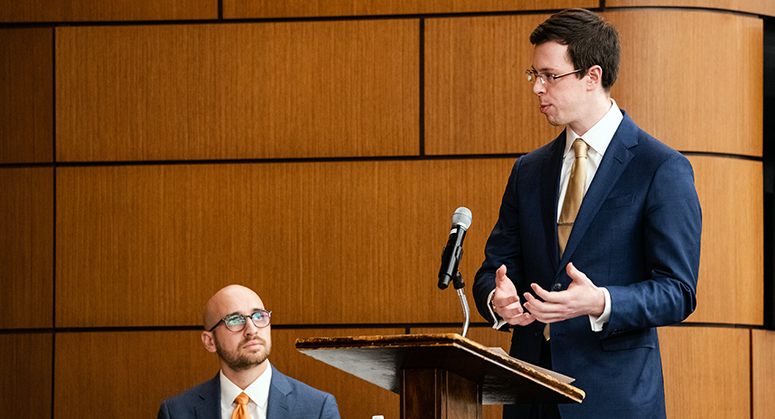 Ryan Shaffer at lectern and Jake Gold seated