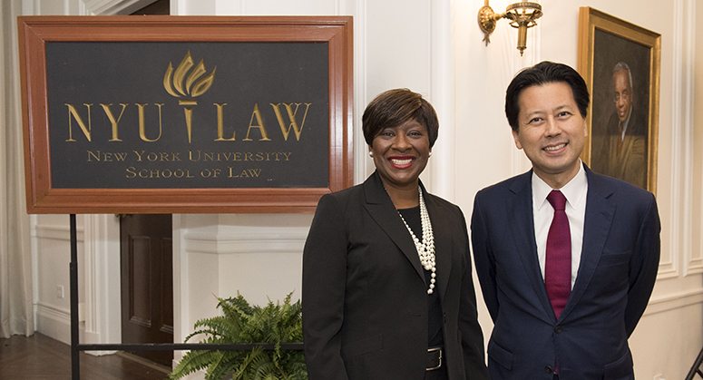  Katherine Phillips and Kenji Yoshino pose by the NYU Law sign