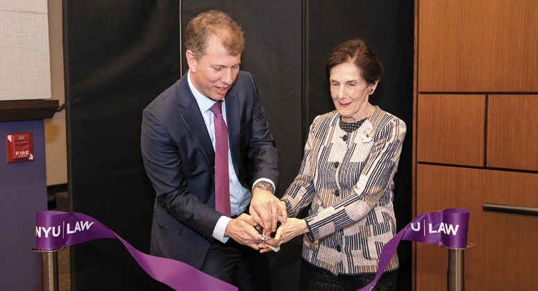 Trevor Morrison and Rita Hauser cut a ceremonial ribbon