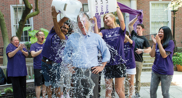 Students pouring a bucket of ice water on Trevor Morrison