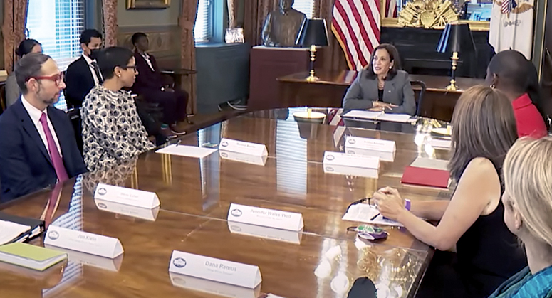 Melissa Murray at conference table with Vice President Kamala Harris