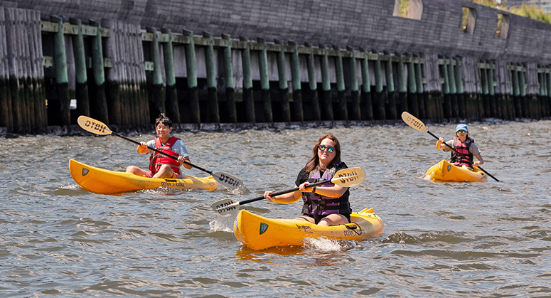 Students paddling kayaks in Hudson River