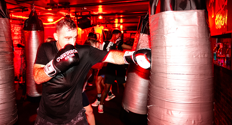 Student hitting punching bag