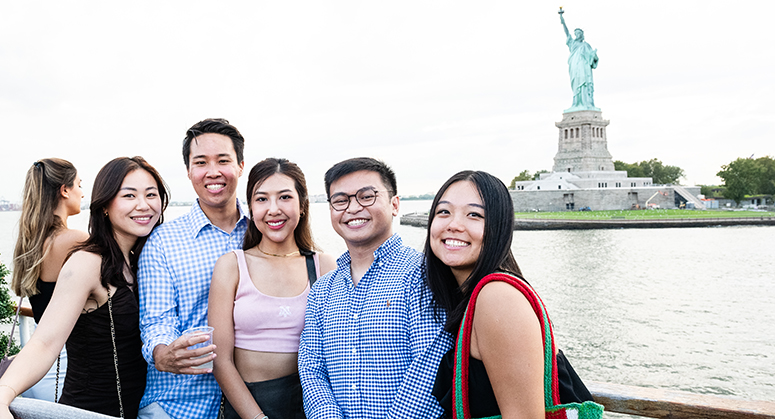 NYU Law students with Statue of Liberty in the background