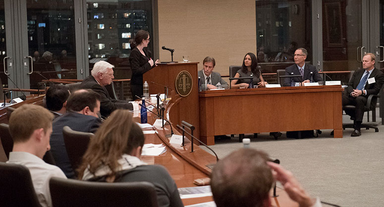 The moderator addressing the panel