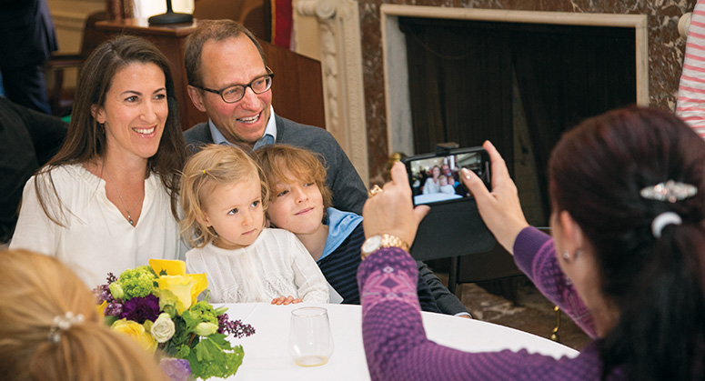 An alumni family having their photo taken at their table at the 2018 NYU Law Reunion