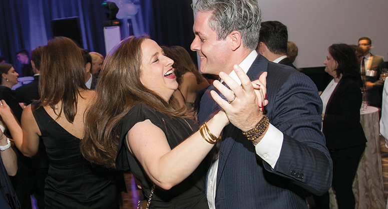 Two NYU Law alumni dancing together at the 2018 NYU Law Reunion