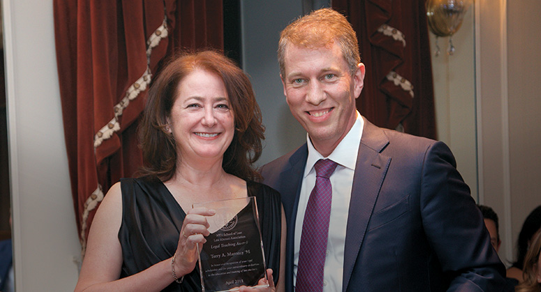 Terry Maroney '98 with Dean Trevor Morrison receiving her award at the 2018 NYU Law Reunion