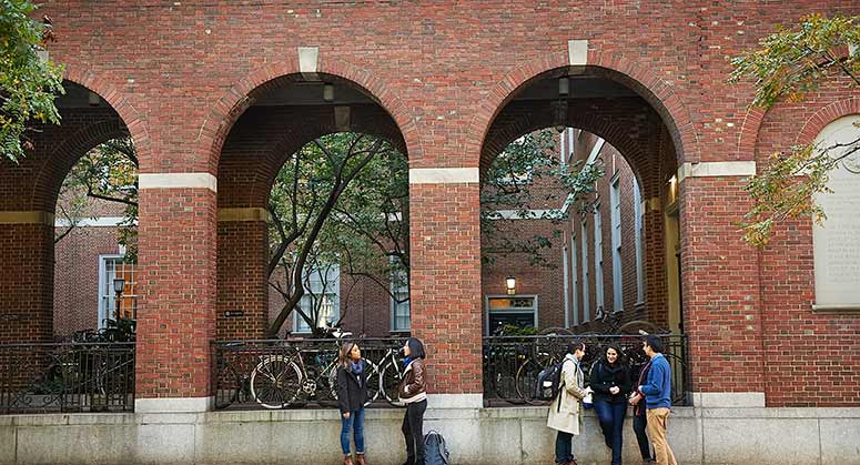 Students talking in front of Vanderbilt Hall arches
