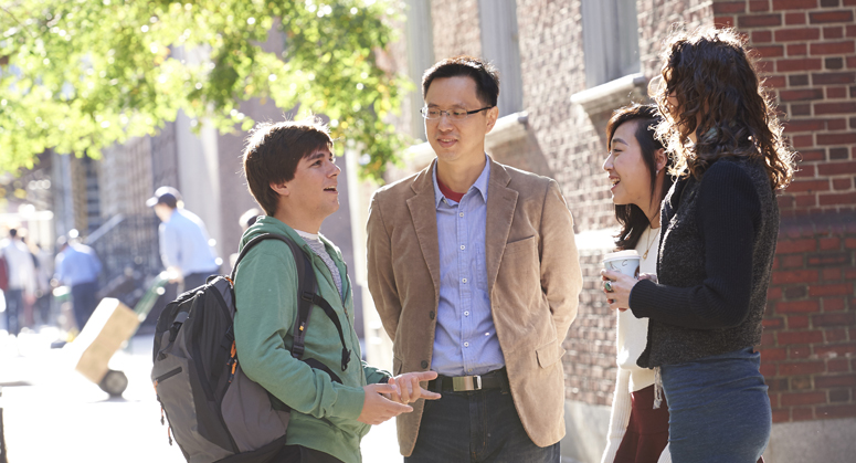 Professor and students talking outside Vanderbilt Hall