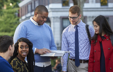 Students looking at book