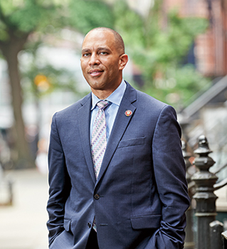 Hakeem Jeffries standing in front of Brooklyn brownstones