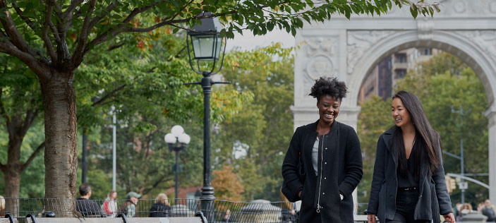 Two students walking in Washington Square Park