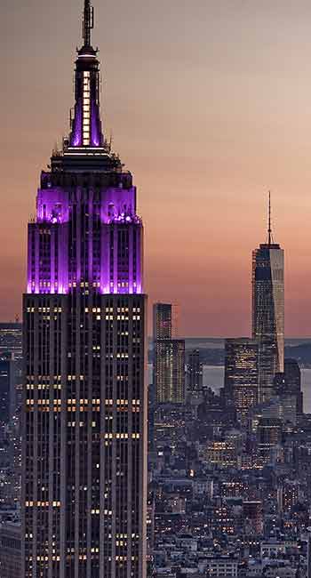 New York City skyline with Empire State Building lit in purple