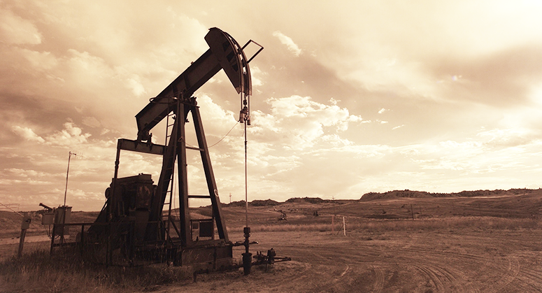 An oil derrick in a barren landscape.