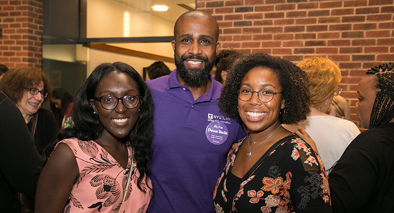 Jason Belk with students smiling at OutLaw/LACA reception