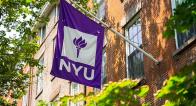 NYU Flag hanging from a building, waving in the wind
