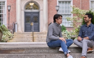 Two students sitting on steps of Vanderbilt Hall courtyard