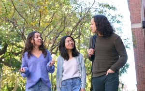 Three students walking near Vanderbilt Hall