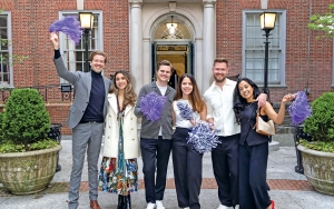 Alum in Vanderbilt Courtyard waving purple pom-poms