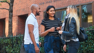 Three students talking outside Furman Hall