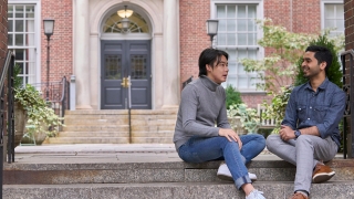 Two students sitting on steps of Vanderbilt Hall courtyard