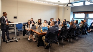 Professor teaching students at a seminar table
