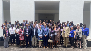 Symposium participants posing outside of Conference site