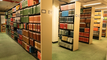 Rows of tall shelves filled with books